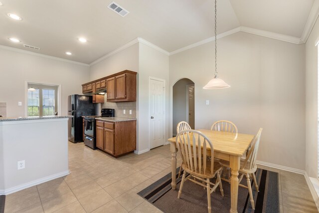 kitchen featuring visible vents, arched walkways, brown cabinets, and black appliances
