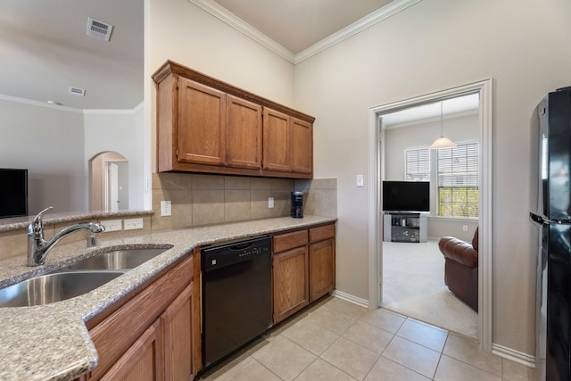 kitchen featuring crown molding, a sink, brown cabinetry, black appliances, and visible vents