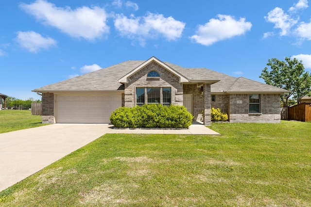 ranch-style home featuring an attached garage, driveway, fence, and a front yard