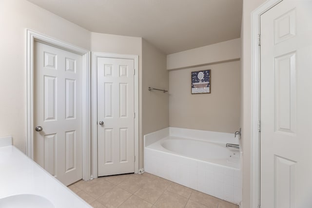 bathroom with a bath and tile patterned floors