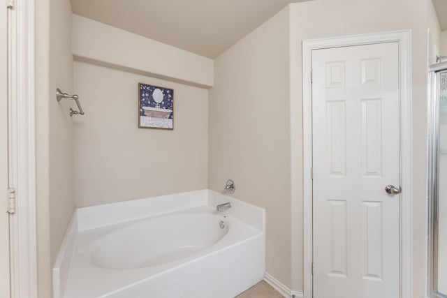 bathroom with a garden tub