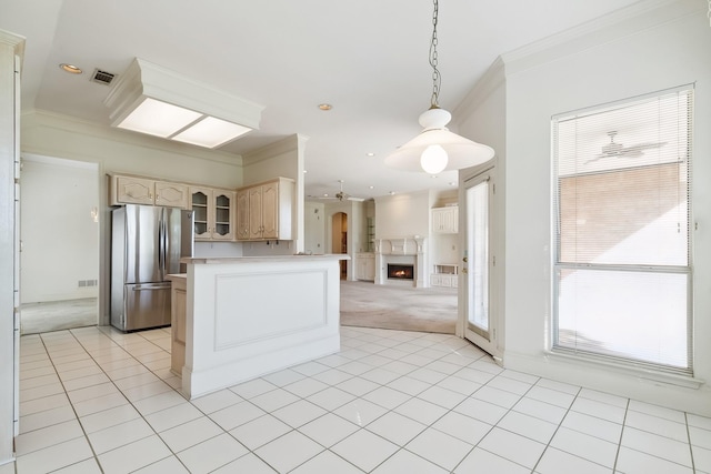 kitchen with open floor plan, visible vents, freestanding refrigerator, glass insert cabinets, and crown molding