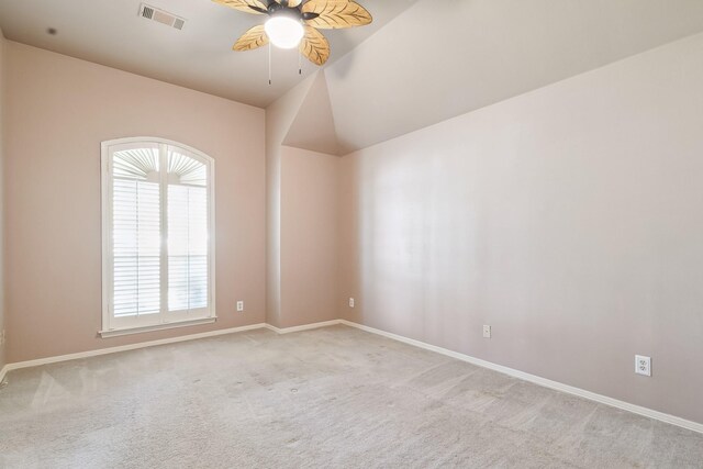 unfurnished room featuring carpet floors, visible vents, a ceiling fan, and plenty of natural light