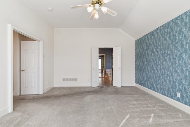 interior space featuring wallpapered walls, visible vents, ornamental molding, and ceiling fan