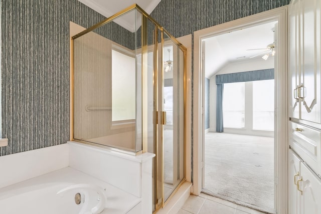 full bath with a shower stall, vaulted ceiling, a ceiling fan, wallpapered walls, and tile patterned flooring