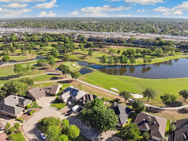 drone / aerial view with view of golf course, a water view, and a residential view