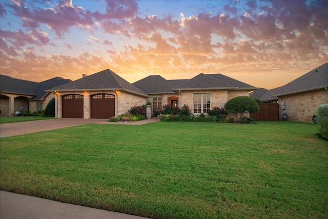 1608 Ridgewood Dr, Waco, TX 76710 - view of front of property featuring a yard, an attached garage, stone siding, and concrete driveway