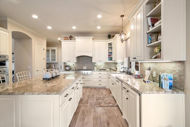 1608 Ridgewood Dr, Waco, TX 76710 - kitchen featuring open shelves, a sink, stainless steel gas stovetop, light wood-style floors, and ornamental molding