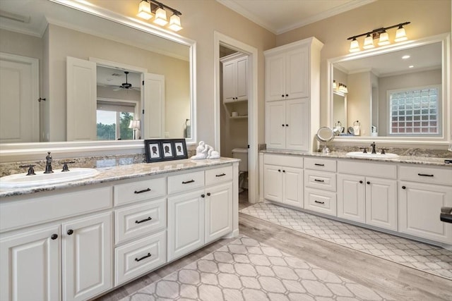 1608 Ridgewood Dr, Waco, TX 76710 - bathroom with toilet, a ceiling fan, wood finished floors, crown molding, and vanity