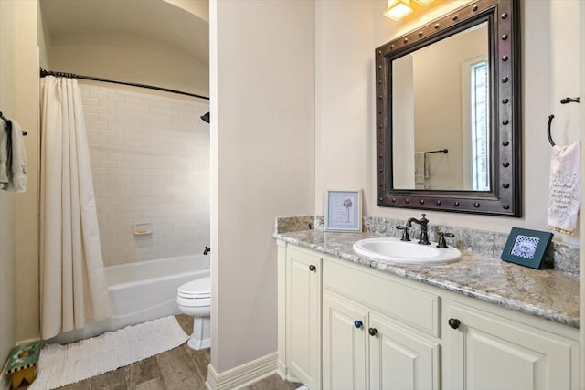 1608 Ridgewood Dr, Waco, TX 76710 - full bath with wood finished floors, toilet, vanity, baseboards, and shower / tub combo