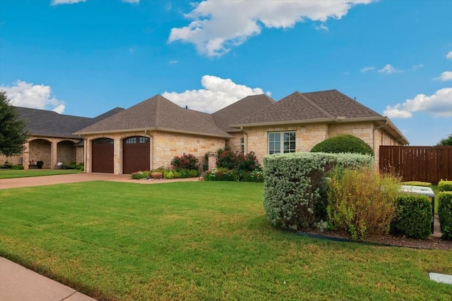 1608 Ridgewood Dr, Waco, TX 76710 - view of front of home featuring a garage, stone siding, a front yard, and a shingled roof