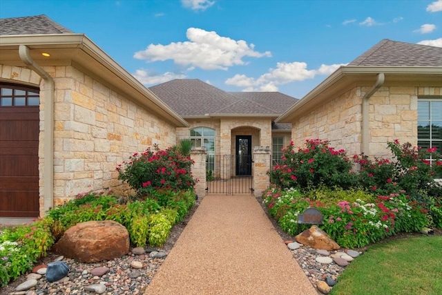 1608 Ridgewood Dr, Waco, TX 76710 - doorway to property featuring a gate, roof with shingles, stone siding, and a garage