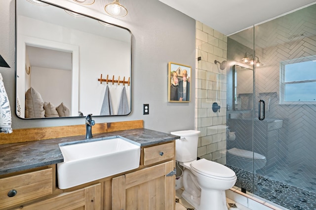 bathroom with vanity, tile patterned floors, a shower stall, and toilet