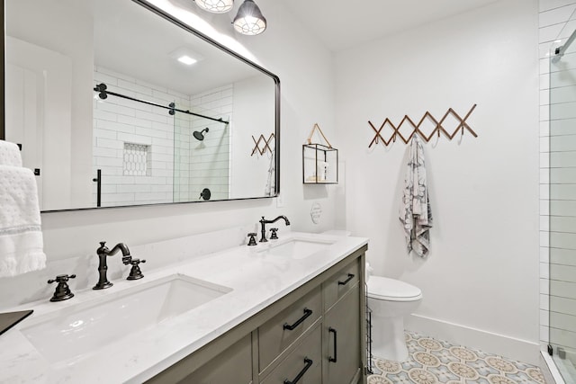 bathroom featuring double vanity, toilet, a sink, and a stall shower