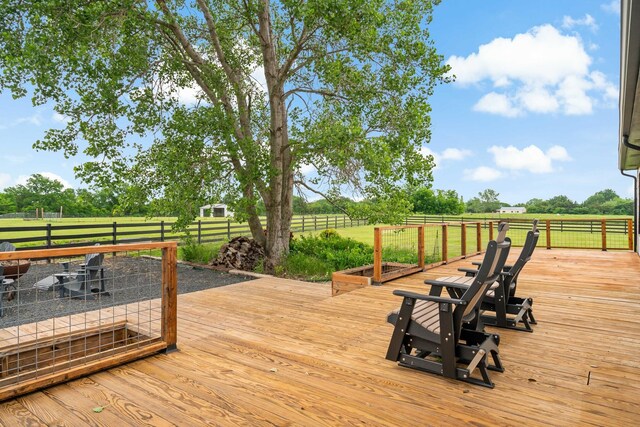 deck featuring fence and a rural view