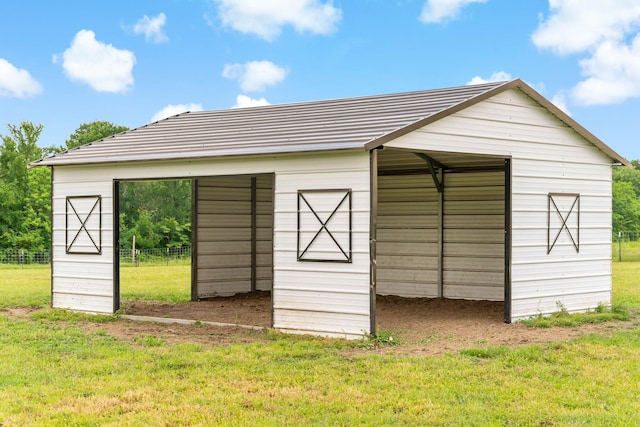 view of pole building featuring fence and a yard