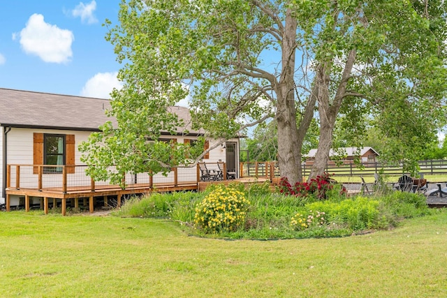 view of yard featuring a wooden deck and fence