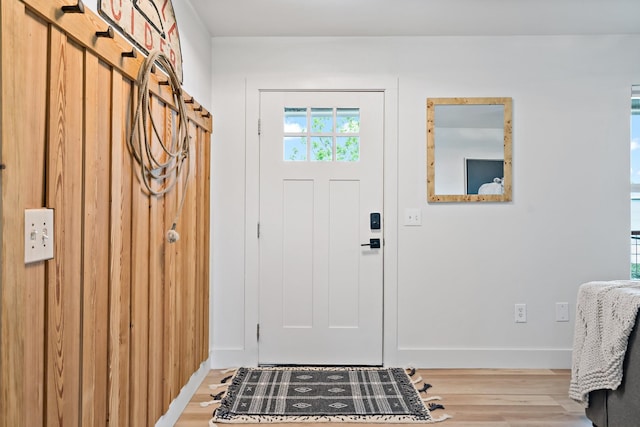 foyer entrance with baseboards and light wood finished floors