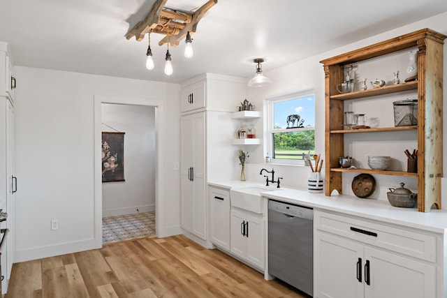 bar featuring baseboards, a sink, light wood-style flooring, and dishwasher