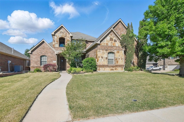 view of front of property with brick siding, cooling unit, stone siding, and a front lawn