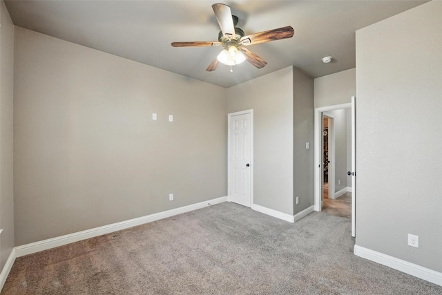 unfurnished room featuring baseboards, a ceiling fan, and carpet flooring