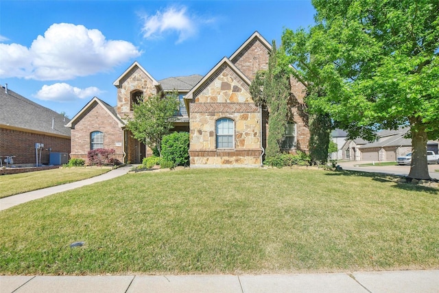 view of front of property featuring brick siding, central AC, stone siding, and a front lawn