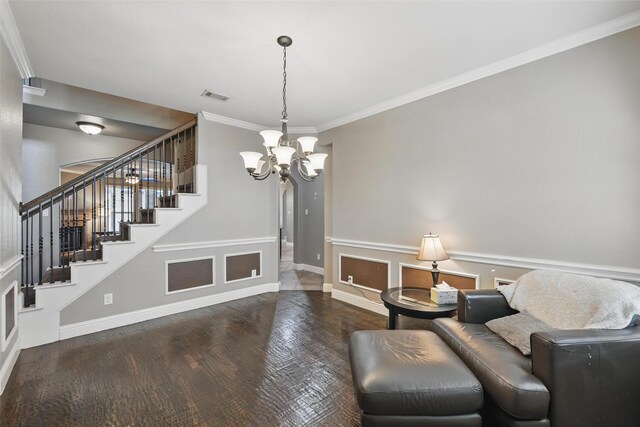 living area with wood finished floors, stairs, baseboards, a notable chandelier, and visible vents
