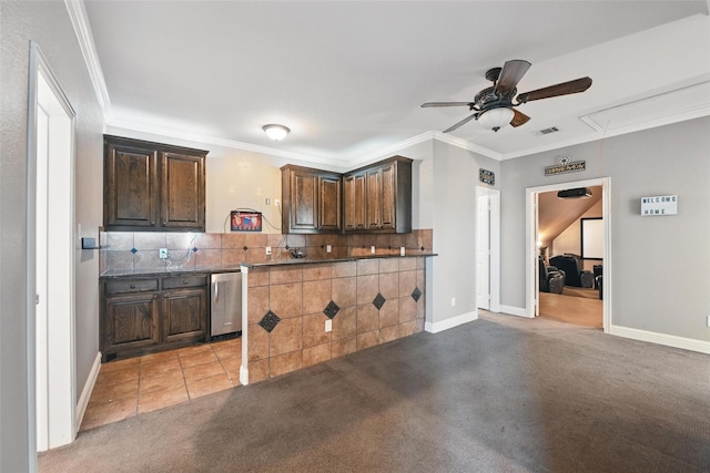 kitchen with dark countertops, a ceiling fan, decorative backsplash, light colored carpet, and visible vents