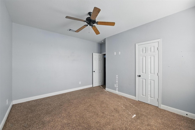 unfurnished bedroom featuring ceiling fan, baseboards, visible vents, and carpet