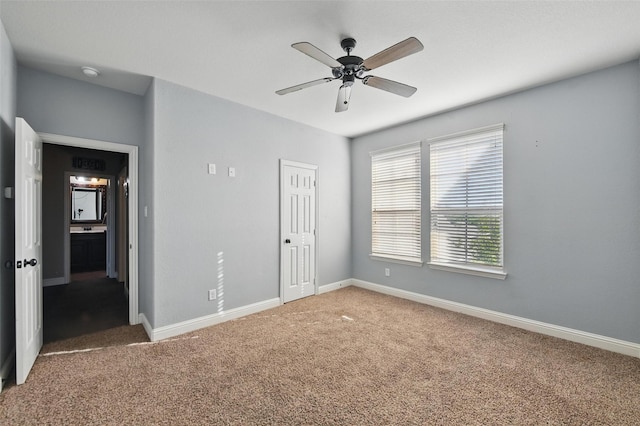 unfurnished bedroom with baseboards, a ceiling fan, and carpet flooring