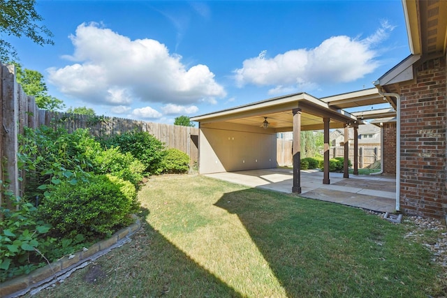 view of yard featuring a ceiling fan, a fenced backyard, and a patio