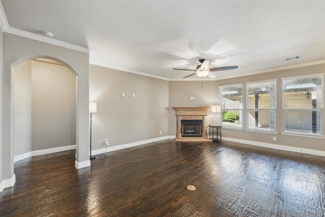unfurnished living room with arched walkways, wood finished floors, visible vents, and ceiling fan