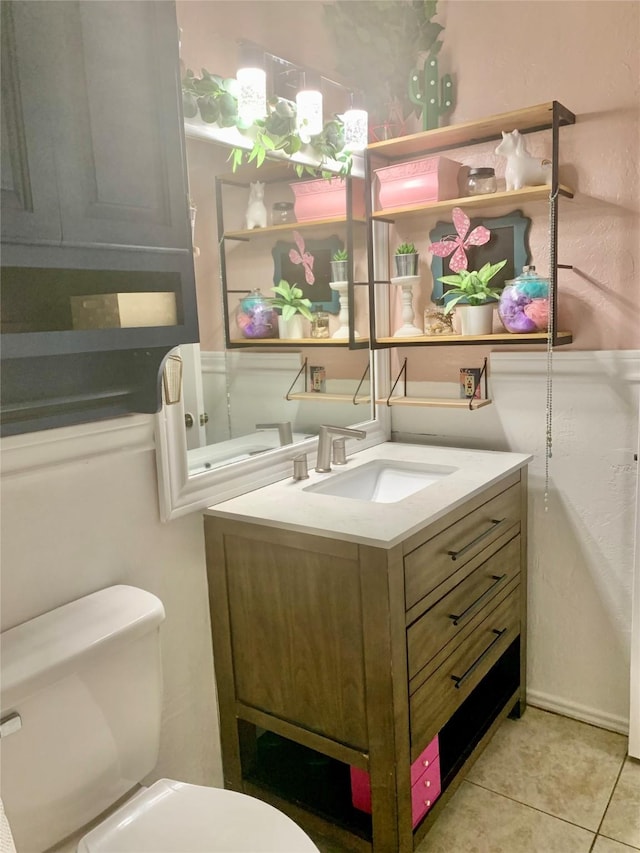 bathroom featuring toilet, vanity, and tile patterned floors