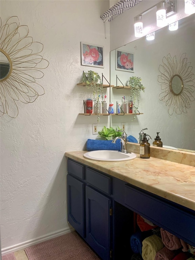 bathroom with baseboards and vanity