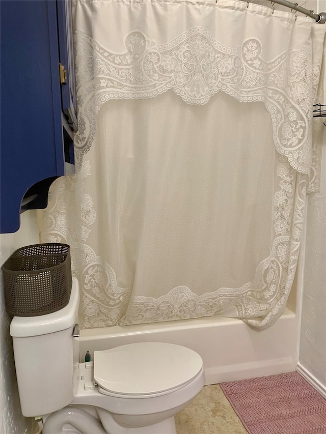 full bath with shower / tub combo with curtain, toilet, and tile patterned floors