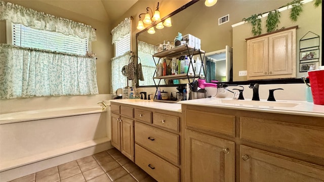 bathroom featuring a garden tub, vaulted ceiling, tile patterned floors, a sink, and double vanity