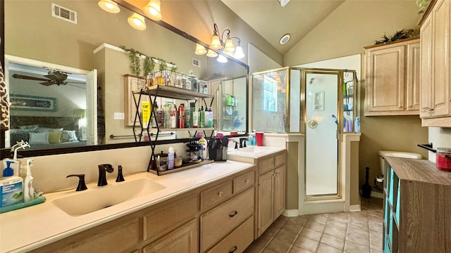 bathroom featuring lofted ceiling, visible vents, tile patterned floors, and a sink