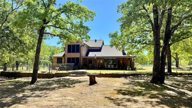 rear view of house featuring fence and a patio area