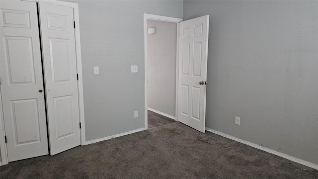 805 S 4th St, Bonham, TX 75418 - unfurnished bedroom featuring dark colored carpet, baseboards, and a closet