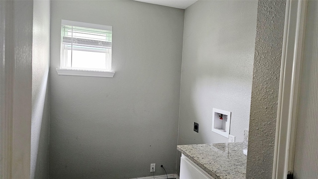 805 S 4th St, Bonham, TX 75418 - washroom featuring electric dryer hookup, hookup for a washing machine, and baseboards