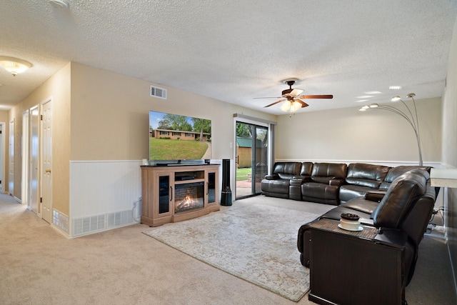 717 Van Horn Dr, Irving, TX 75060 - living area featuring a ceiling fan, visible vents, carpet floors, and a textured ceiling
