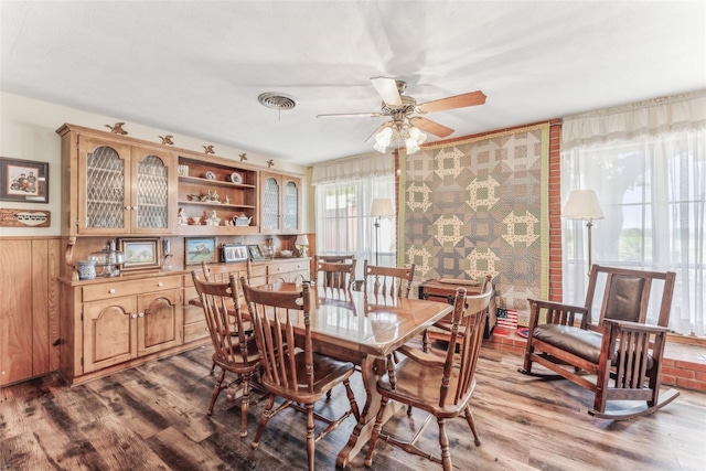 3055 Midway Rd, Grapevine, TX 76092 - dining room with wood finished floors, visible vents, a ceiling fan, and a wainscoted wall