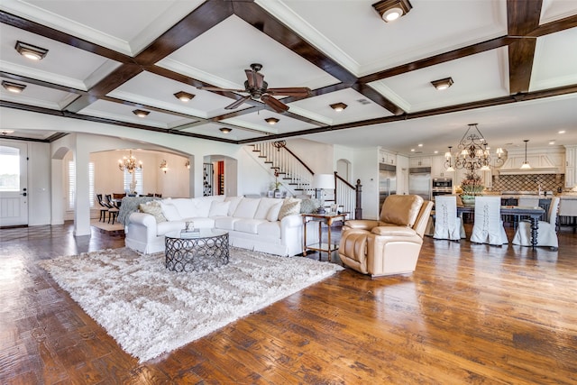 6100 Old Clarksville Rd, Reno, TX 75462 - living area featuring arched walkways, stairway, ceiling fan with notable chandelier, and coffered ceiling