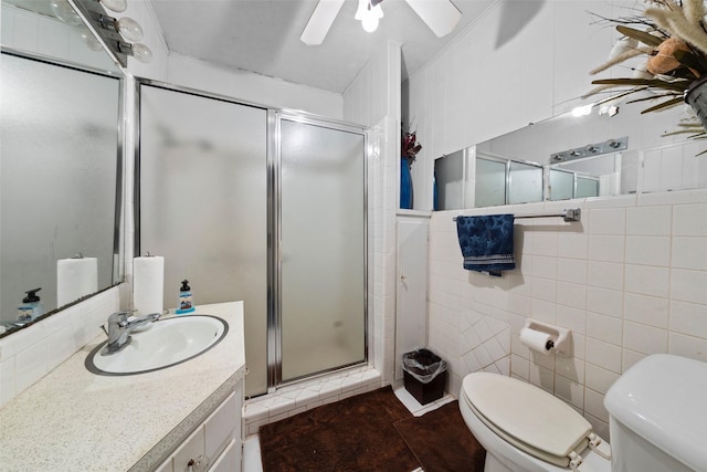 1302 E Mclennan Ave, Mart, TX 76664 - full bathroom featuring toilet, tile walls, a stall shower, vanity, and a ceiling fan