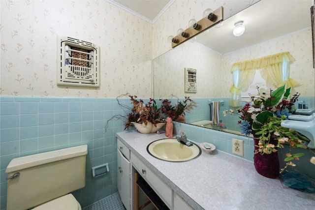 1302 E Mclennan Ave, Mart, TX 76664 - bathroom with ornamental molding, wallpapered walls, wainscoting, vanity, and tile walls