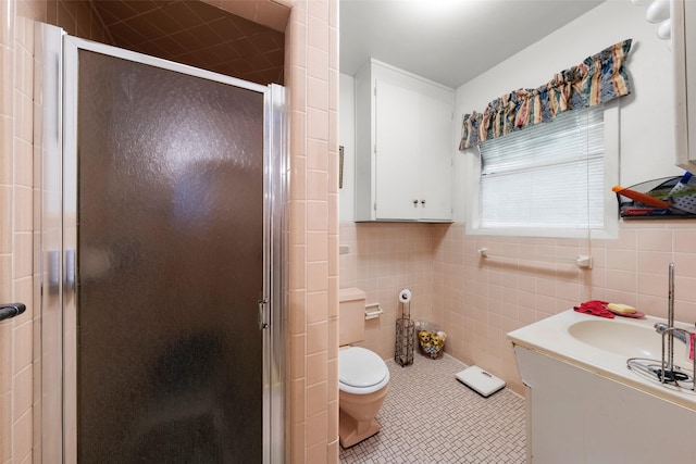 1302 E Mclennan Ave, Mart, TX 76664 - full bathroom with tile walls, a stall shower, toilet, tile patterned floors, and vanity