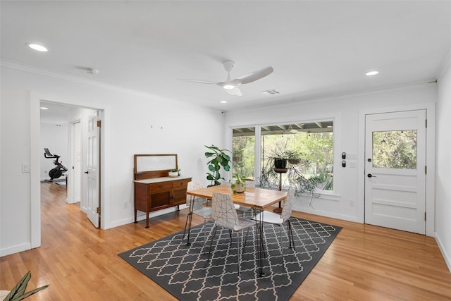 office area featuring ornamental molding, light wood-style flooring, ceiling fan, and visible vents