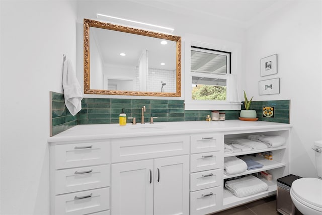 bathroom with backsplash, crown molding, vanity, toilet, and recessed lighting