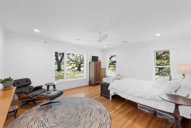 bedroom featuring crown molding, visible vents, recessed lighting, light wood-type flooring, and a ceiling fan