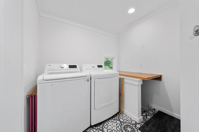 laundry area with laundry area, independent washer and dryer, crown molding, light tile patterned floors, and baseboards